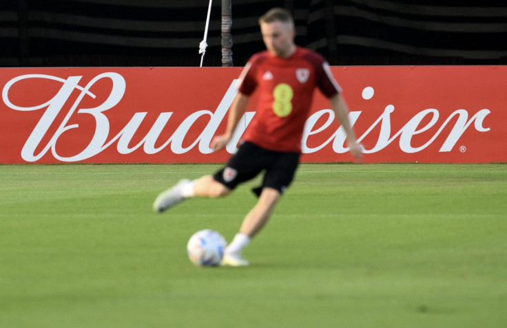 A player of the Wales team is backdropped by a billboard of beer sponsor Budweiser as he takes part in a training session at the Al Saad SC in Doha on Nov. 19, 2022, ahead of the Qatar 2022 World Cup. Qatar and FIFA announced a stadium ban on beer sales o