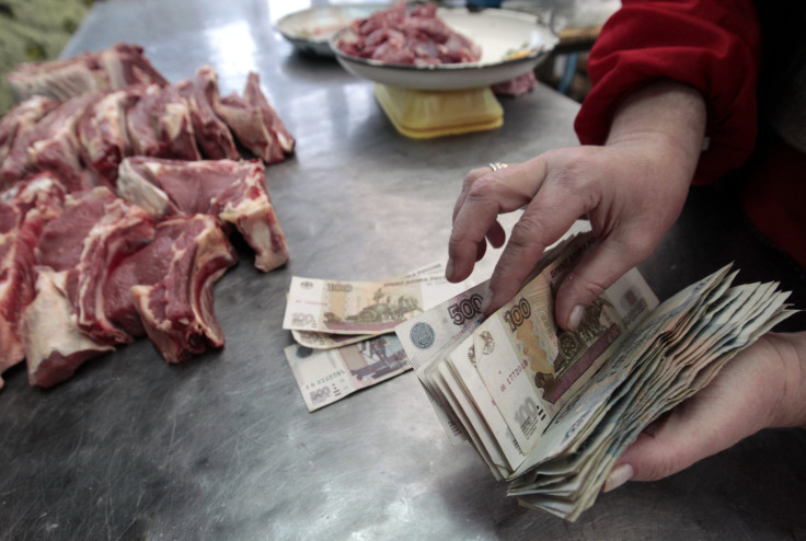 A vendor handles Russian ruble banknotes at a market in Stavropol, southern Russia, Jan. 21, 2016.