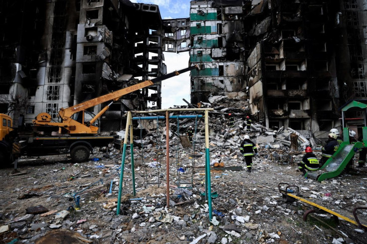 A rescuer walks during a search operation for bodies under the rubble of a building destroyed by Russian shelling, amid Russia's Invasion of Ukraine, in Borodyanka, Kyiv region, Ukraine April 11, 2022.