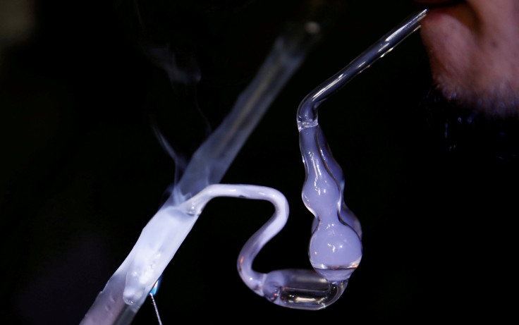 A drug addict uses a glass water pipe to smoke shabu, or methamphetamine, at an undisclosed drug den in Manila, June 20, 2016.