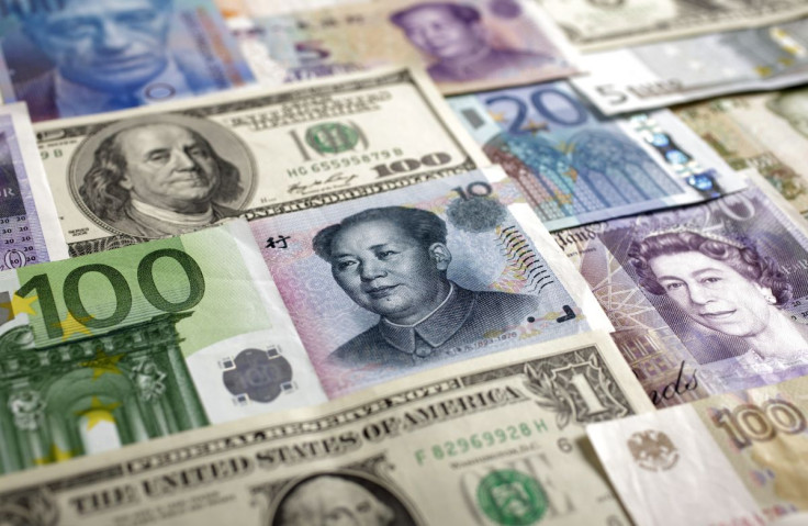 Arrangement of various world currencies including Chinese Yuan, Japanese Yen, US Dollar, Euro, British Pound, Swiss Franc and Russian Rouble pictured in Warsaw