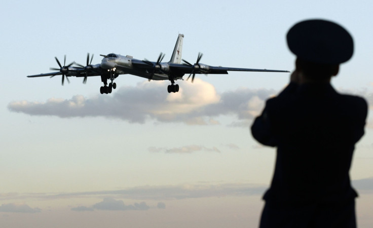 A Russian Tu-95 Bear strategic bomber crashed Tuesday because of the failure of three propulsion systems. In the picture, a Russian officer takes a picture of a Tu-95 bomber, or "Bear," at a military airbase in Engels, some 900 km (559 miles) south of Mos