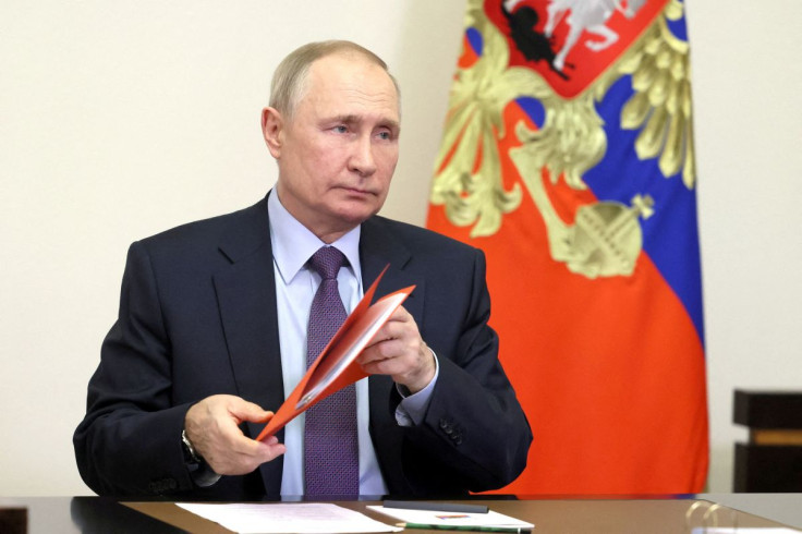 Russian President Putin chairs a meeting with members of the Security Council outside Moscow