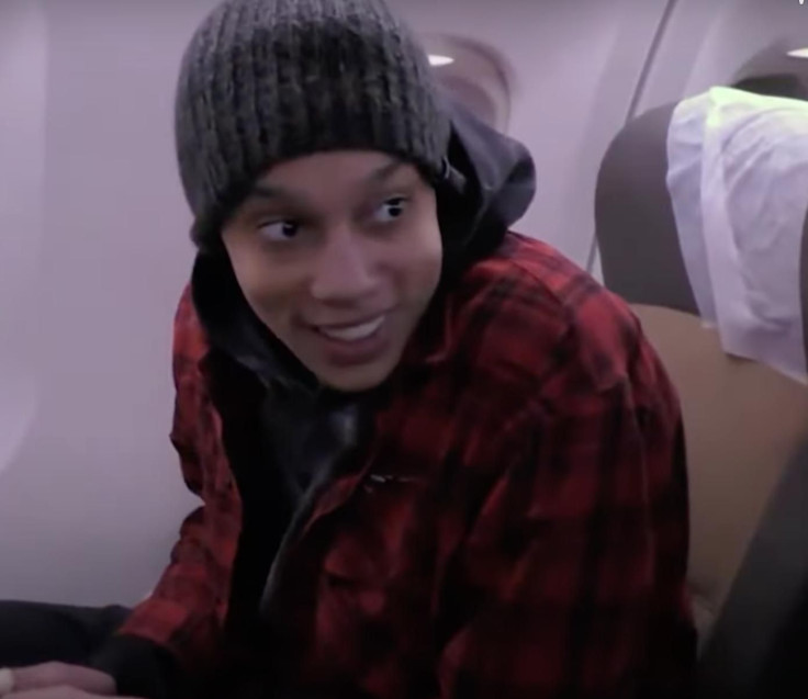Brittney Griner smiling on the plane en-route back to the U.S.