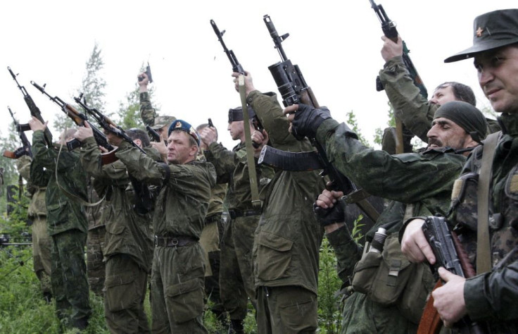 Ukraine denies it was involved in a prisoner exchange involving two Russian soldiers. Pictured: Combatants fire their weapons in honor of Aleksey Mozgovoi, a militant leader of the separatist self-proclaimed Luhansk People's Republic, during the funeral o