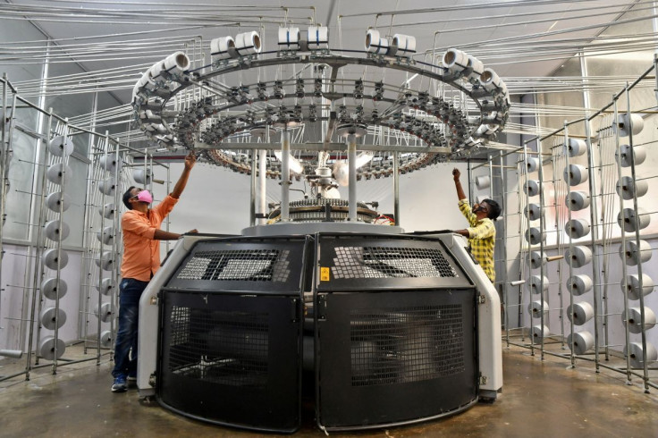 Workers operate a knitting machine at a textile factory of Texport Industries in Hindupur town in the southern state of Andhra Pradesh, India, February 9, 2022.