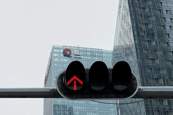 A partially removed company logo of China Evergrande Group is seen on the facade of its headquarters, near a traffic light in Shenzhen, Guangdong province, China January 10, 2022.