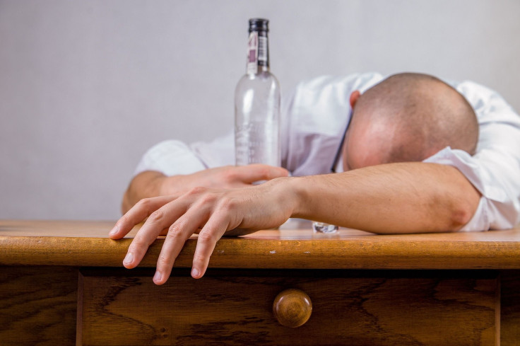 Representation. A man passed out from drinking alcohol.