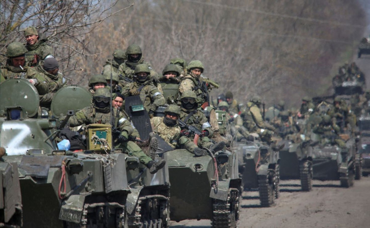 Service members of pro-Russian troops ride on armoured vehicles in the course of Ukraine-Russia conflict on a road leading to the city of Mariupol, Ukraine April 15, 2022.