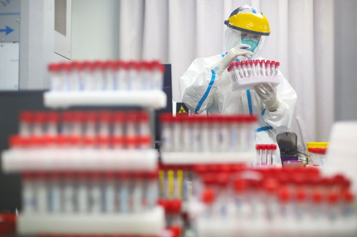 A medical staff in protective suit works at a nucleic acid testing laboratory of Nanjing First Hospital following a citywide mass testing for the coronavirus disease (COVID-19) in Nanjing, Jiangsu province, China July 24, 2021. cnsphoto via