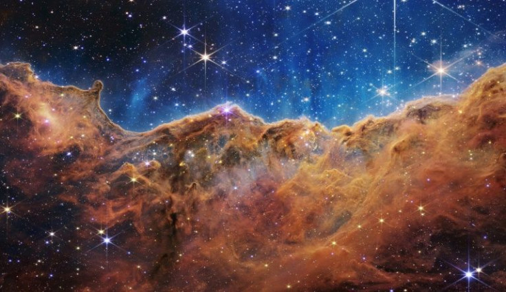 This image from the James Webb Space Telescope shows âmountainsâ and âvalleysâ speckled with glittering stars which is actually the edge of a nearby, young, star-forming region called NGC 3324 in the Carina Nebula