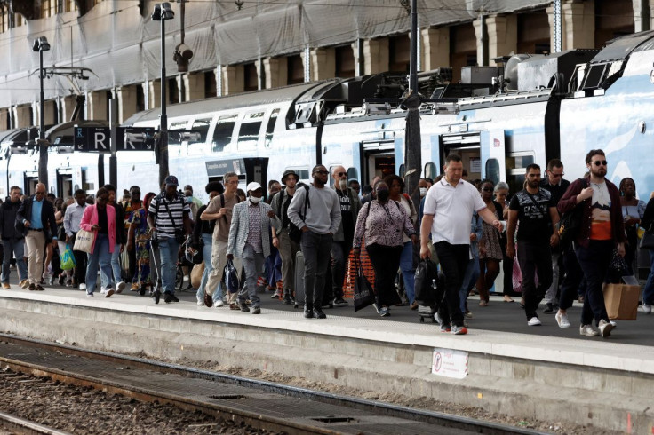 Travelers walk on a plateform during a nationwide strike by France's national state-owned railway company SNCF workers, at Gare de Lyon train station in Paris, France, July 6, 2022.