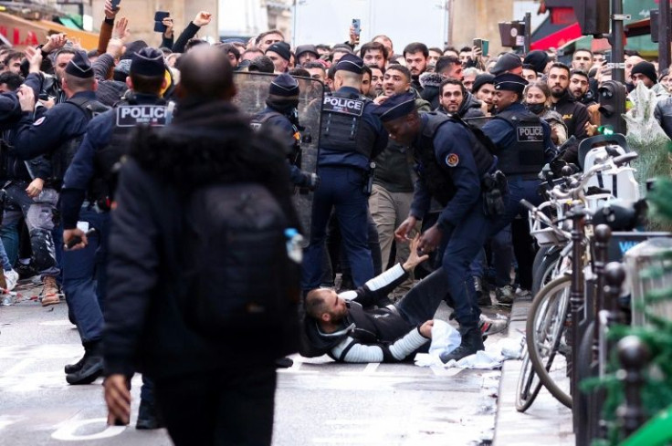 Demonstrators threw objects at police in response, set rubbish bins on fire and erected barricades in Paris