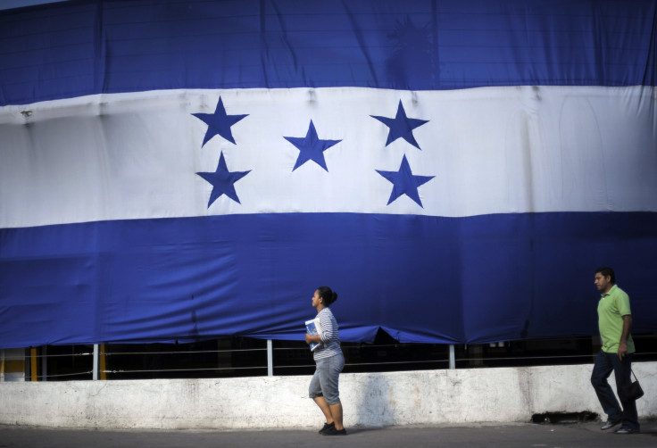 Five Syrian nationals were detained late Tuesday in Tegucigalpa, Honduras. Pictured: A woman and a man walk past a giant Honduran flag in Tegucigalpa Sept. 28, 2012.