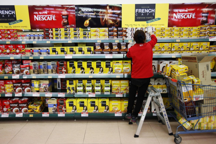 A employee displays products on the shelves of a supermarket in Seoul, South Korea, Nov. 21, 2012.