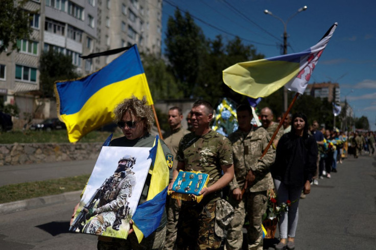 People attend a funeral ceremony for Abdulkarim Gulamov, Ukrainian serviceman, who was killed in a fight against Russian troops in Kherson region on July 17, as Russia's attack on Ukraine continues, in Obukhiv, Kyiv region, Ukraine July 21, 2022.