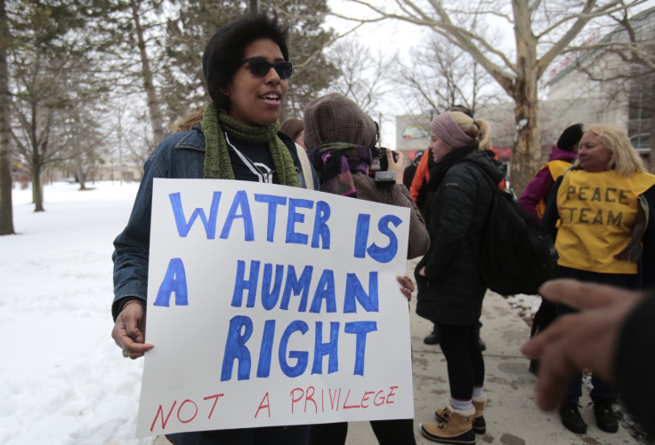 Demonstrators protest over the Flint, Michigan contaminated water crisis outside of the venue where the Democratic U.S. presidential candidates' debate was being held in Flint, Michigan, March 6, 2016.