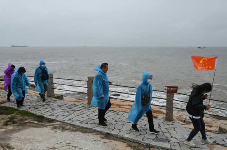 Clusters of tourists milled around snapped selfies by the shore of Pingtan Island