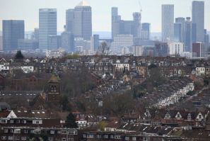 Rows of houses lie in front of the Canary Wharf skyline in London, Britain