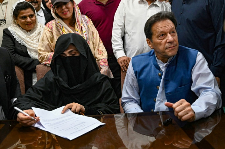 Khan's (R) current wife is Bushra Bibi (L) -- who was also jailed for 14 years on Wednesday in the same graft case -- is a faith healer and religious leader