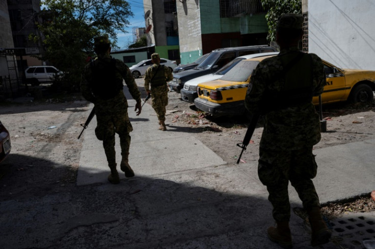 Soldiers patrol the streets of San Salvador in the days leading up to the election