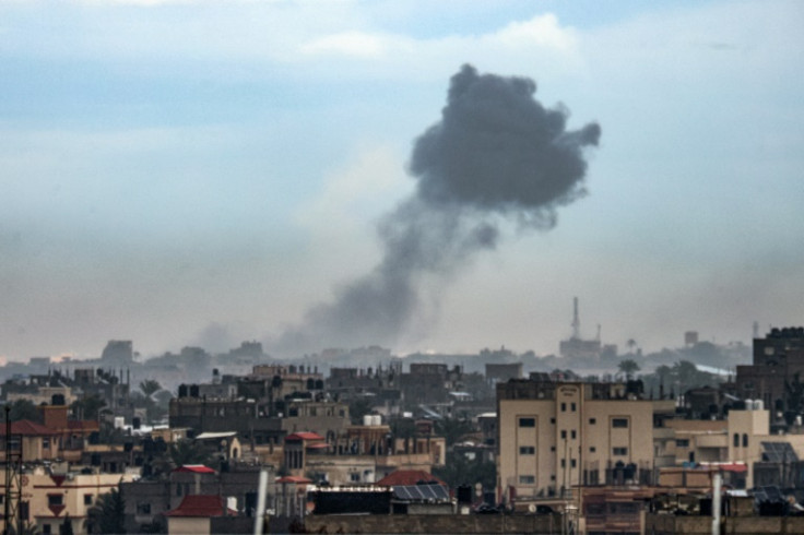 A plume of smoke is seen rising over Khan Yunis from nearby Rafah in the southern Gaza Strip