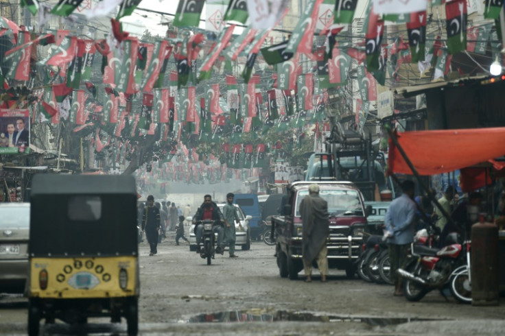 Pakistan Peoples Party (PPP) and Muttahida Qaumi Movement – Pakistan (MQM-P) flags are hung across a street in Karachi on February 4, 2024, ahead of the upcoming general elections