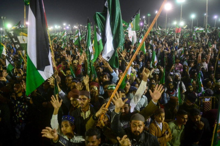 Supporters of Tehreek e Labbaik Pakistan (TLP) party, cheer as they attend an election campaign rally in Karachi on February 4, 2024