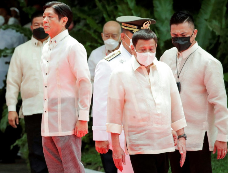 Incoming Philippine President Ferdinand Marcos Jr (L) and outgoing President Rodrigo Duterte (C) take part in the inauguration ceremony for Marcos at the Malacanang presidential palace grounds in Manila on June 30, 2022