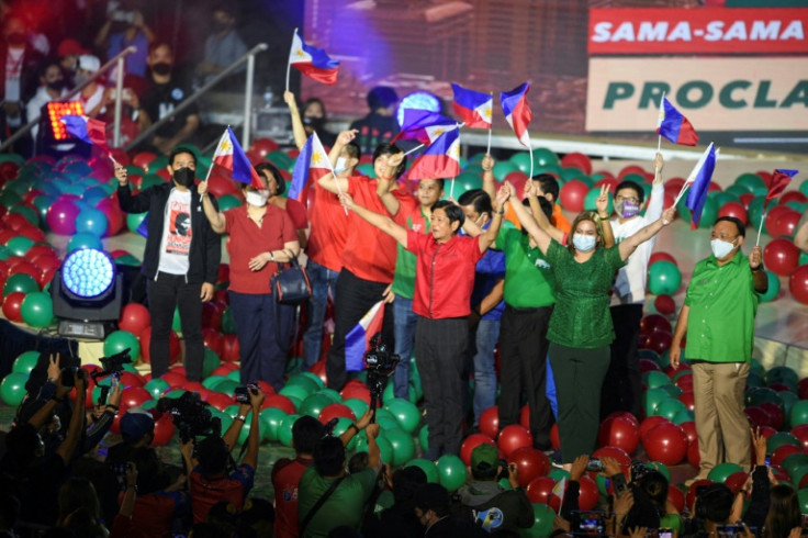 Bongbong Marcos (front L, in red) and his Vice-Presidential candidate Sara Duterte (front R, in Green), daughter of incumbent President Rodrigo Duterte,attend a campaign rally in Bocaue town, Bulacan province, north of Manila on February 8, 2022