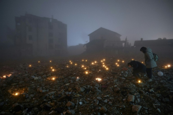 Survivors placed candles at the spots where their loved ones died one year ago
