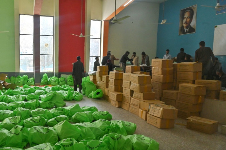 Workers prepare voting materials for distribution in Islamabad ahead of Thursday's election