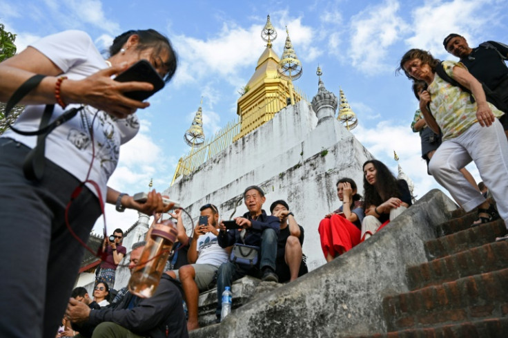 Tourists inject much-needed money into Laos' shaky economy but present locals with a dilemma, as foreign tour groups dominate and change cultural activities