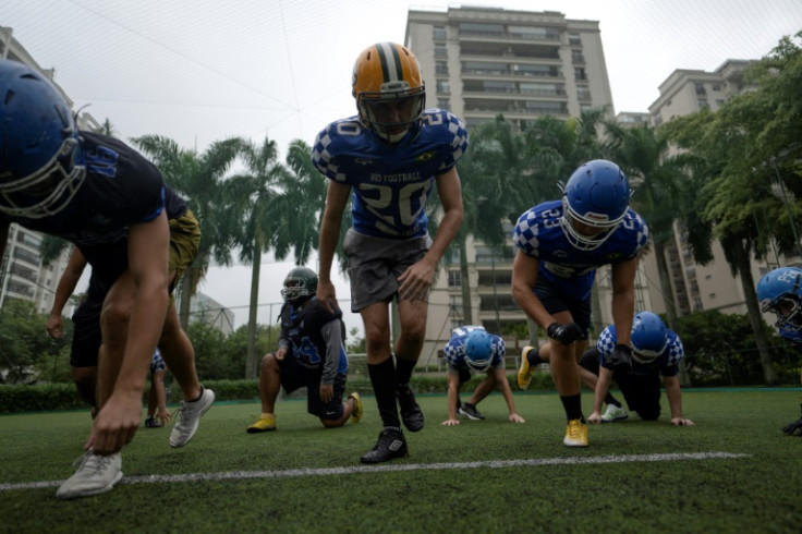 American football players work out during a training session of the Rio Football Academy team inside the luxury condominium Peninsula, located at the Barra da Tijuca neighborhood in Rio de Janeiro, Brazil