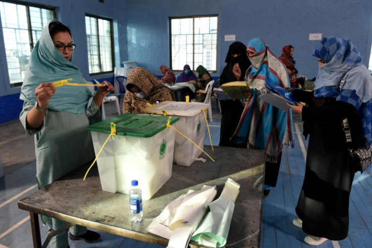 Pakistan election workers open ballot boxes as they begin counting votes in the country's national election