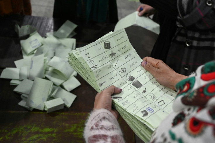 Election officials count ballot papers after the closing of polls in Pakistan