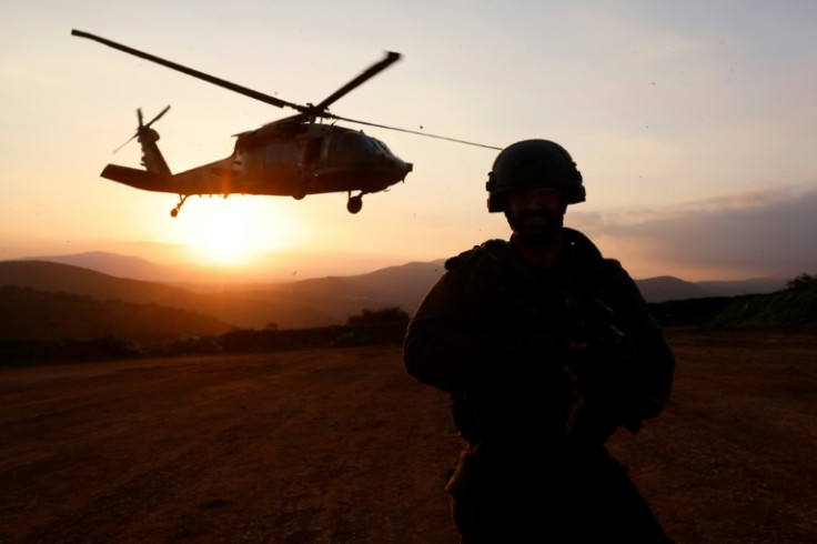 An Israeli soldier looks on as a helicopter takes off near the Lebanon border