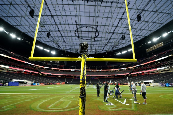 Workers put the finishing touches to the Allegiant Stadium surface ahead of Sunday's Super Bowl in Las Vegas