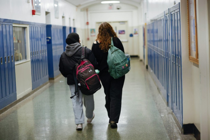 Rawda Elbatrawish (L) and  Liora Pelavin are seen in a corridor at Teaneck High School