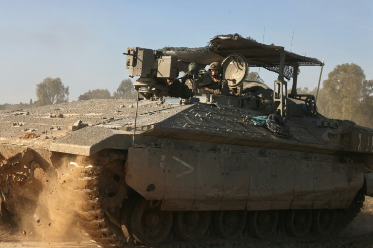 An Israeli military armoured vehicle rolls near the border with the Gaza Strip