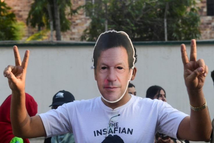 A man wearing a mask of jailed former Pakistan prime minister Imran Khan protests against alleged election rigging in Karachi