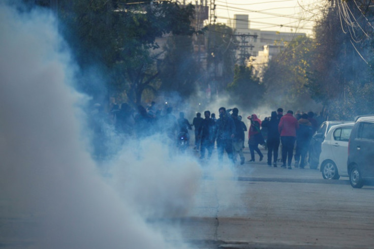 Police fired tear gas at supporters of Imran Khan's Pakistan Tehreek-e-Insaf party after they protested in Rawalpindi on Sunday and warned they would take tough action against illegal gatherings