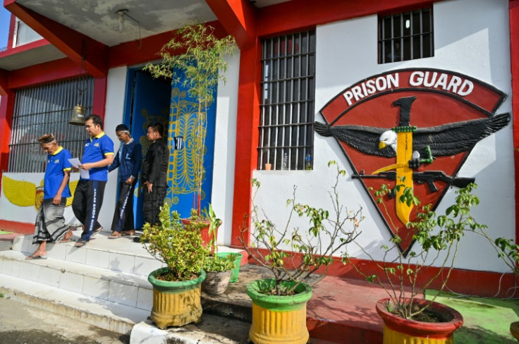 Inmates at a jail in Banda Aceh go to cast their ballots at a polling station in the prison