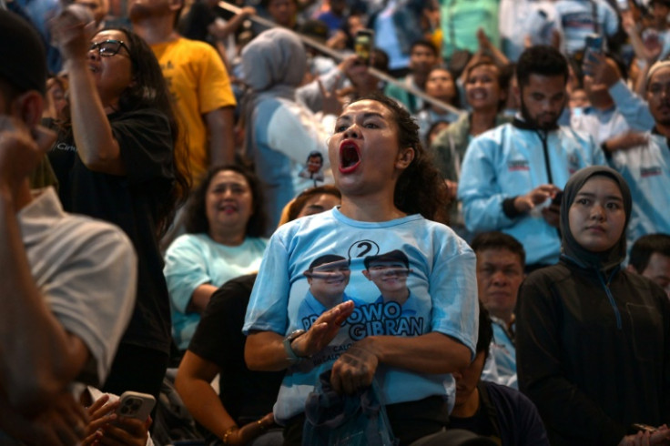 A supporter cheers as Prabowo Subianto addresses the crowd  after claiming victory in the Indonesian presidential election