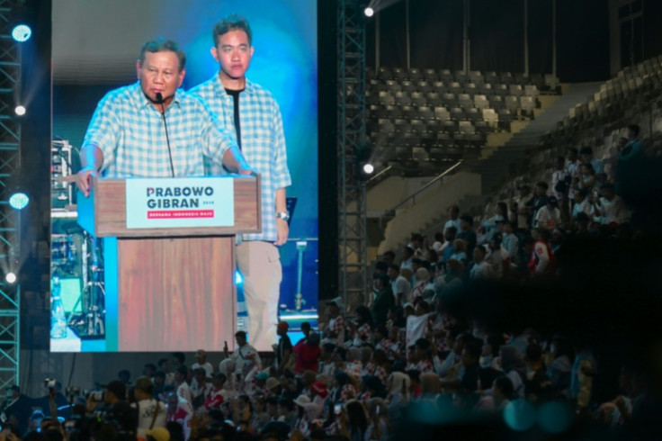 Prabowo Subianto (L) and running mate Gibran Rakabuming Raka, son of Indonesian President Joko Widodo, are seen on a giant screen at a Wednesday night rally