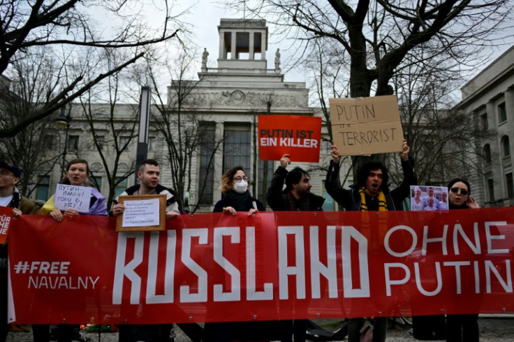 Protesters hold a banner which reads 'Russia without Putin' in front of the Russian embassy in Berlin