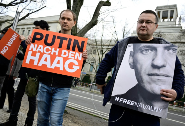 A demonstrator holds a portrait of late Russian opposition leader Alexei Navalny in front of the Russian embassy in Berlin