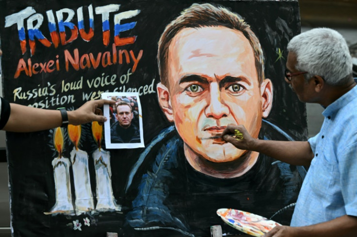 Mumbai school teacher Prithviraj Kambli gives final touches to a portrait of Navalny