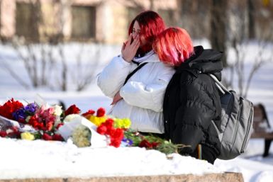 A young woman cries after laying flowers for Navalny at the Solovetsky Stone, a monument to political repression, in Moscow on February 20, 2024