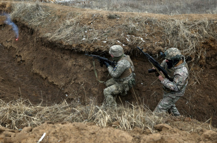 Ukrainian servicemen take position in a trench during a military training exercise near the front line in the Donetsk region